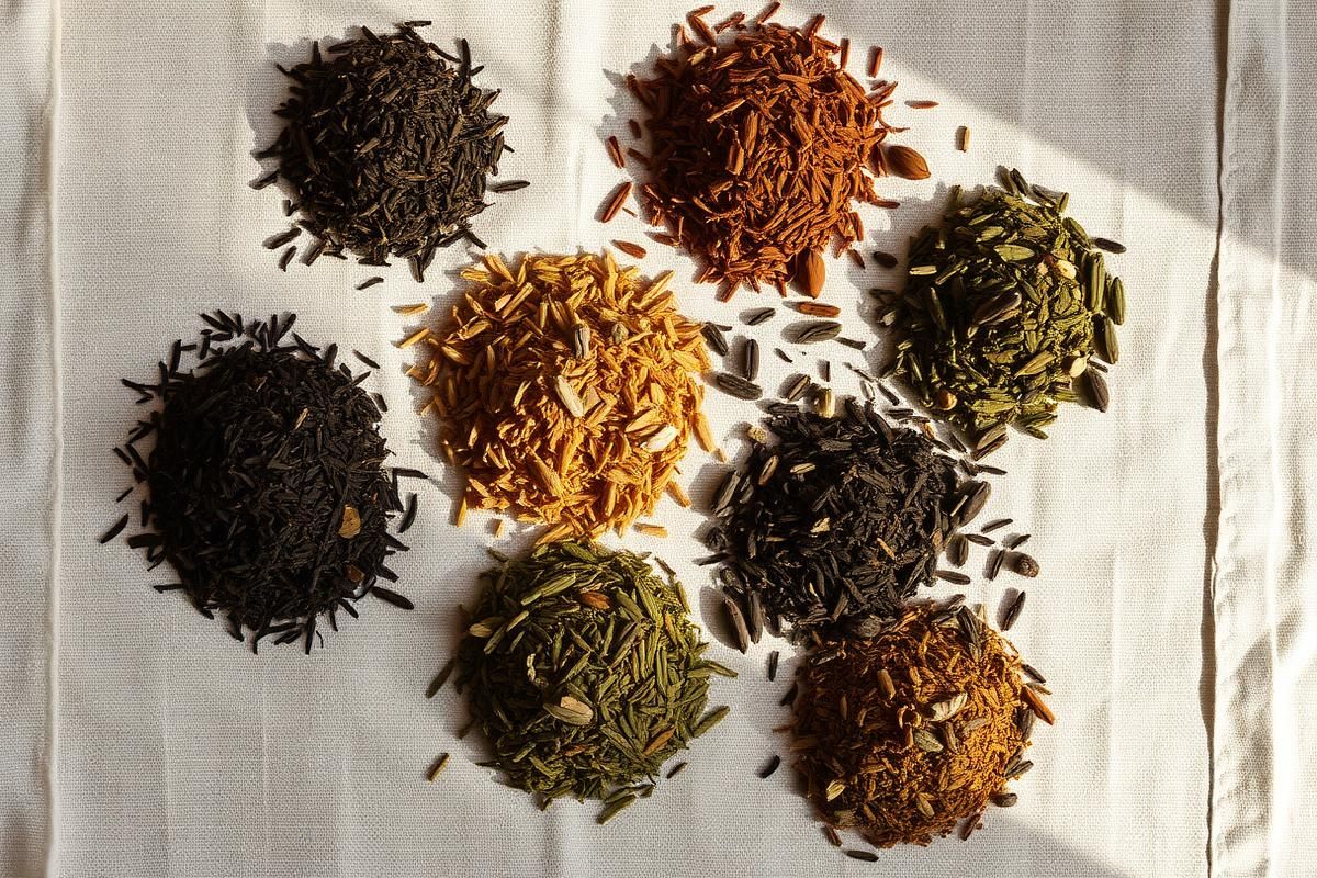 Several tins and pouches of loose leaf tea lined up on a shelf